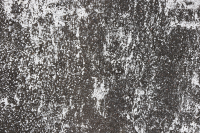 Road asphalt texture. Bitumen surface structure with white paint stains.