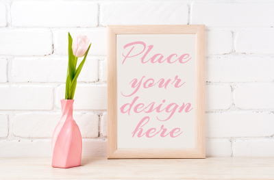 Wooden frame mockup with soft pink tulip in swirled vase