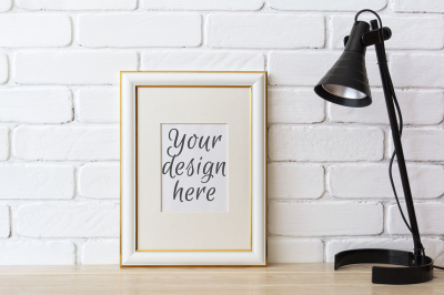 Gold decorated frame mockup with black table lamp