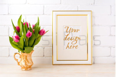 Gold decorated frame mockup with bright pink tulips bouquet