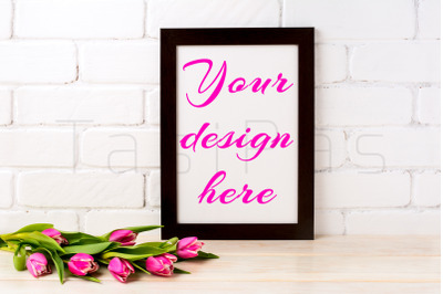 Black brown frame mockup with rich magenta pink tulips bouquet