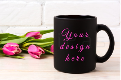 Black coffee mug mockup with rich magenta pink tulips bouquet