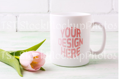 White coffee mug mockup with tender pink tulip flower.