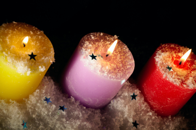 Three candles with artificial snow.