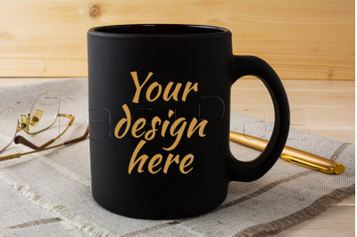 Black coffee mug mockup with glasses and pen