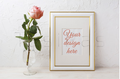 Gold decorated frame mockup with rose in exquisite glass vase