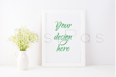 White frame mockup with baby&#039;s breath flowers.