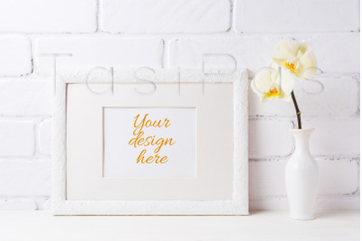 White frame mockup with soft yellow orchid in vase.