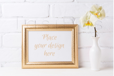 Golden&amp;nbsp; landscape frame mockup with soft yellow orchid in vase.