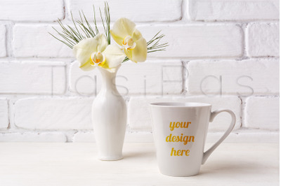 White coffee latte mug mockup with soft yellow orchid in vase.&amp;nbsp;