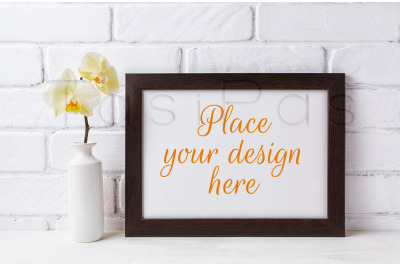 Black brown&amp;nbsp; landscape frame mockup with soft yellow orchid in vase.&amp;nbsp;