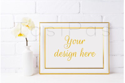 Gold decorated landscape frame mockup with soft yellow orchid in vase.