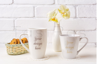 Two white coffee latte and cappuccino mug mockup with soft yellow orch