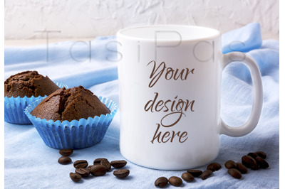 White mug mockup with coffee beans and two chocolate muffins