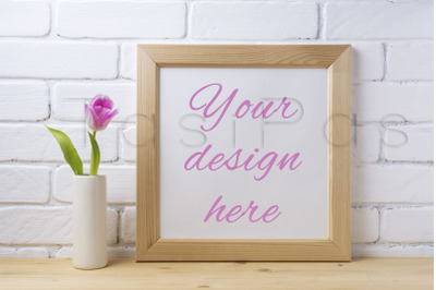 Wooden square frame mockup with pink tulip