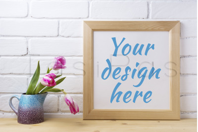 Wooden square frame mockup with pink tulip in purple blue vase