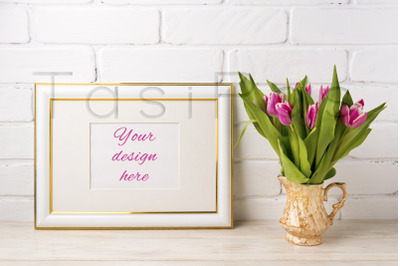 Gold decorated landscape frame mockup with bright pink tulips in golde
