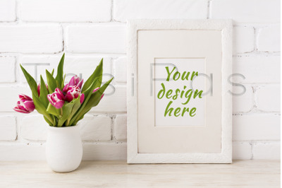 White frame mockup with magenta pink tulip in the flower pot.