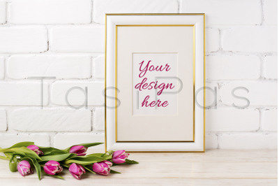 Gold decorated frame mockup with magenta tulips bouquet.