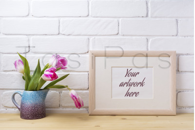 Wooden landscape frame mockup with pink tulip in purple pitcher