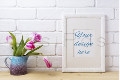 White frame mockup with pink tulip in blue pitcher