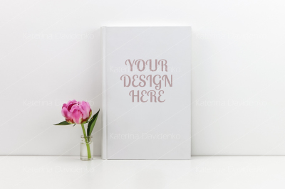 White book mockup with a pink peony flower