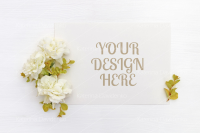 Mockup with a blank A5 paper sheet, white flowers