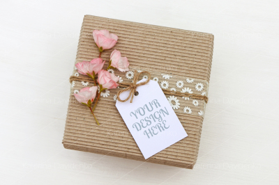 Gift box with empty tag mockup, flowers