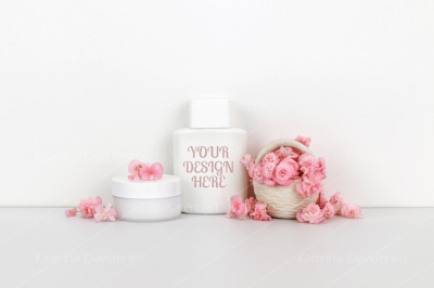 Cosmetics mockup with pink flowers, bottle contain