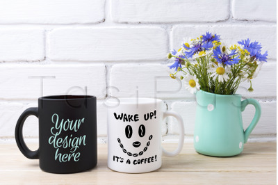 White and black mug mockup with cornflower and daisy