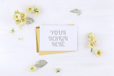 Postcard mockup whith flowers and envelope, on white background
