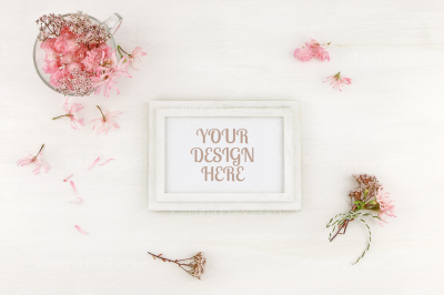 Flatlay wooden frame mockup with pink flowers, on white background