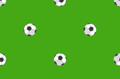 Soccer balls over green field seamless pattern