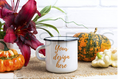 White campfire mug mockup with pumpkin and red lily.