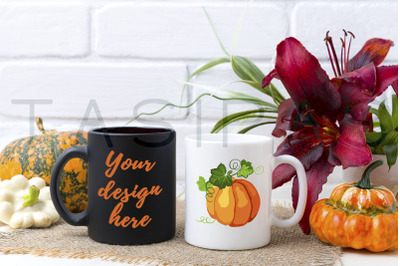 White and black mug mockup with pumpkin and red lily.