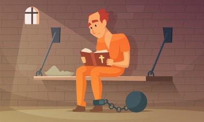 Prisoner sitting in cell and reading bible