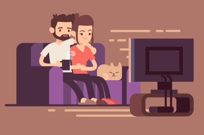 Relaxed happy young couple watching tv at home in living room