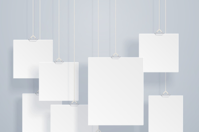 Blank hanging photo frames or poster templates with drop shadows on wa