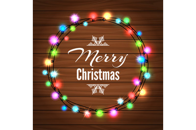 Christmas light garland on wood background