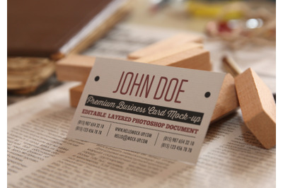 Business card template on letters on newspapers background