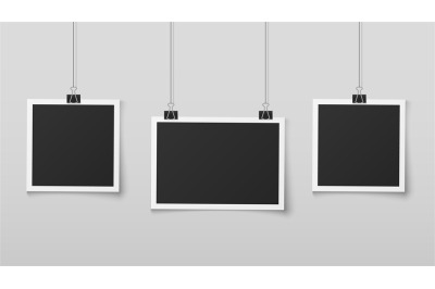 Hanging photo frames. Blank photos frame hangs on ropes with clips, wa