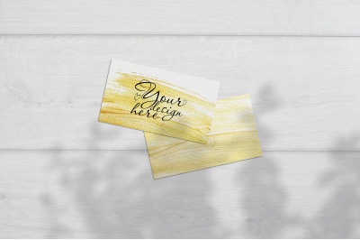 Business card Mockup. Natural overlay lighting shadows the leaves