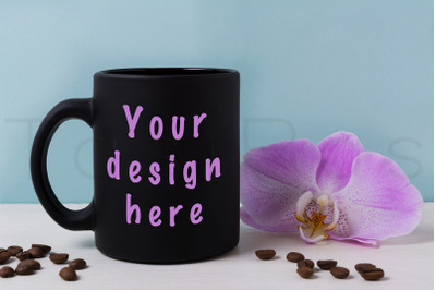 Black mug mockup with orchid and coffee beans.