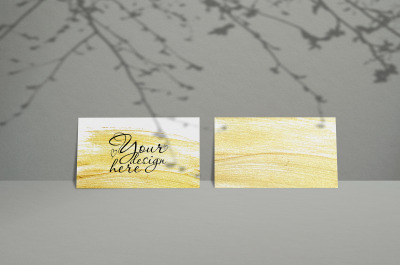 Business card Mockup. Natural overlay lighting shadows the leaves