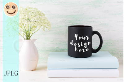 Black coffee mug mockup with books and tender white flowers.