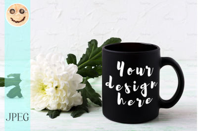 Black coffee mug mockup with white chrysanthemum