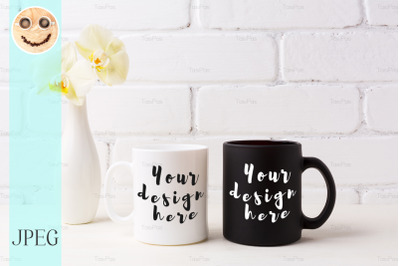 White and black mug mockup with soft yellow orchid in vase&nbsp;