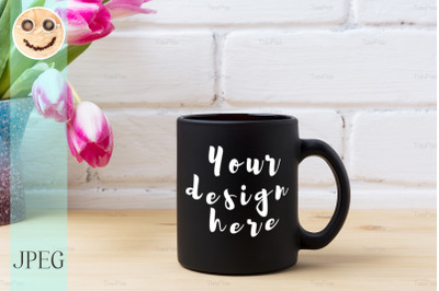 Black coffee mug mockup with magenta tulip