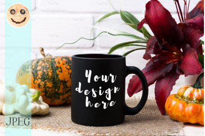 Black coffee mug mockup with pumpkin and red lily