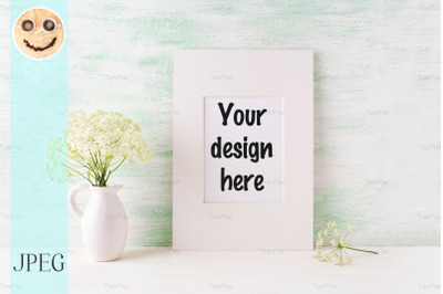 Easy white frame mockup with tender wild flowers in pitcher